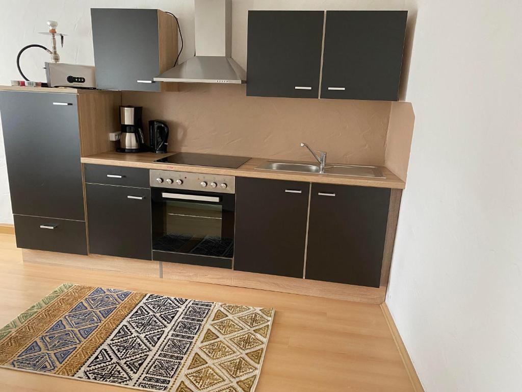 a small kitchen with a sink and a stove at Ferienhaus-Aladdin in Garmisch-Partenkirchen