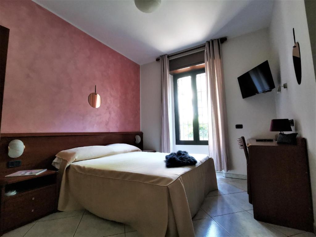 a hotel room with a bed and a window at Hotel Venini in Milan