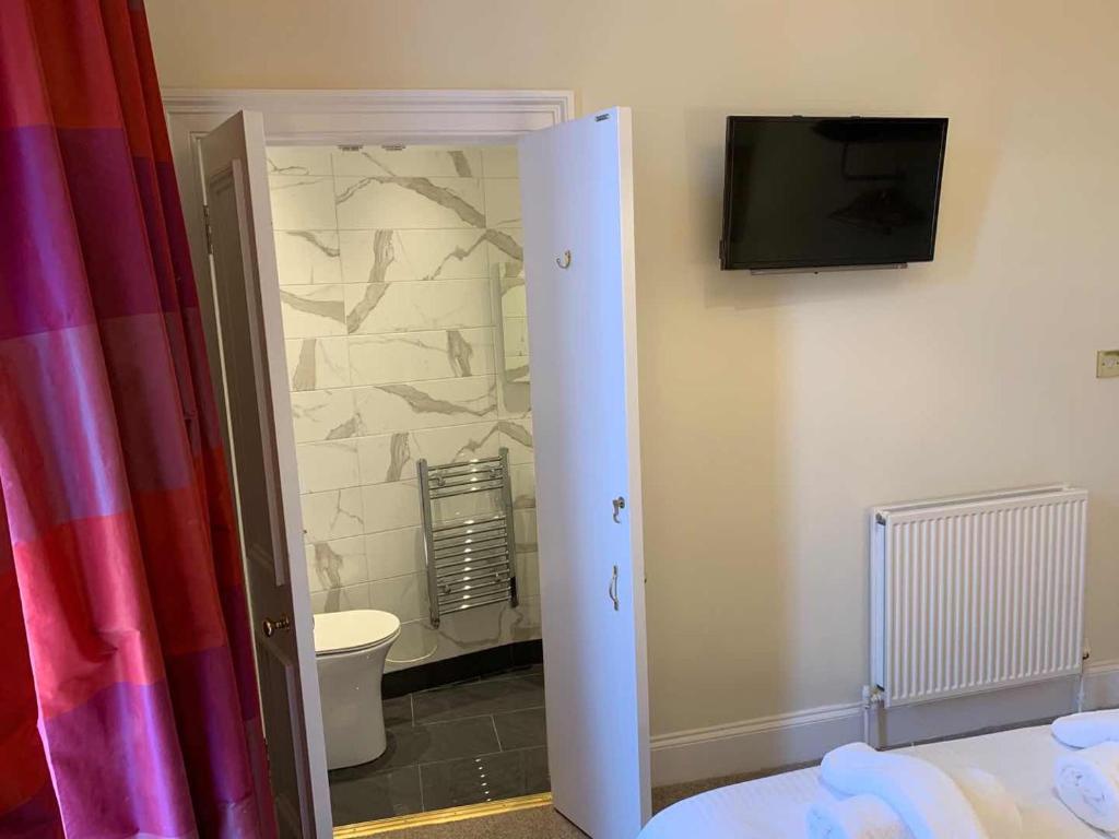Postel nebo postele na pokoji v ubytování Southside Guest House