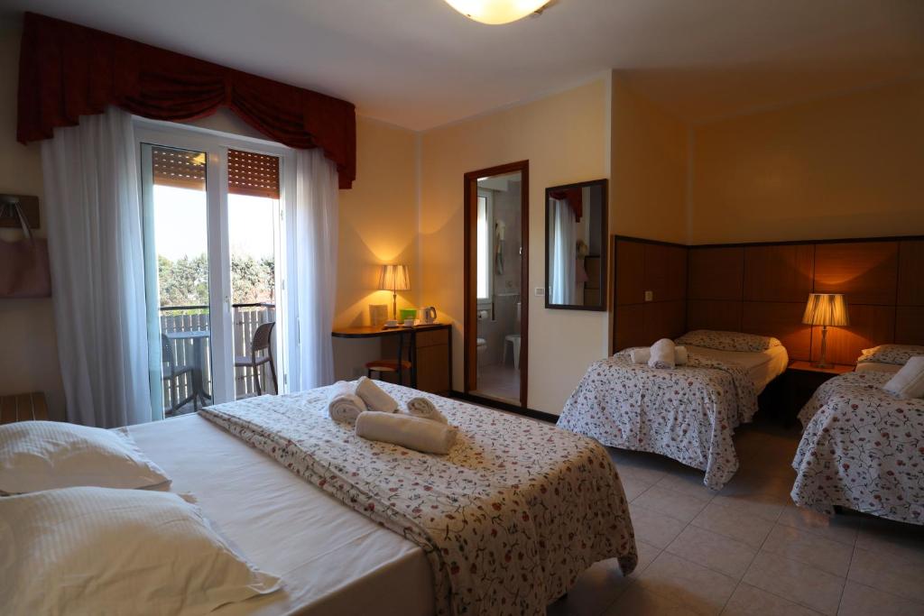 Postel nebo postele na pokoji v ubytování Hotel Righetto Fronte Mare