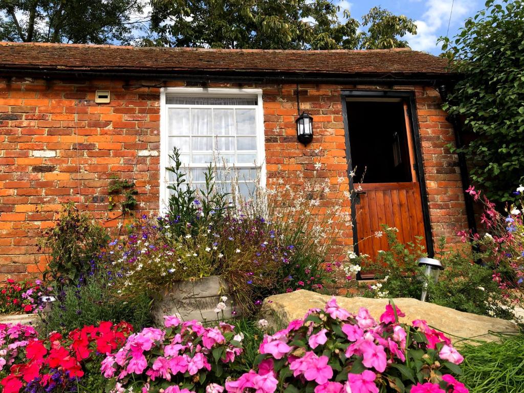 a brick house with flowers in front of it at Beachborough Park in Folkestone
