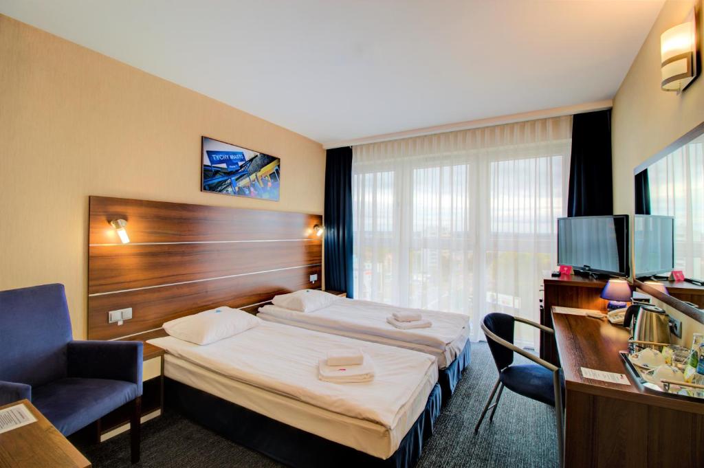 Postel nebo postele na pokoji v ubytování Hotel Tychy Prime