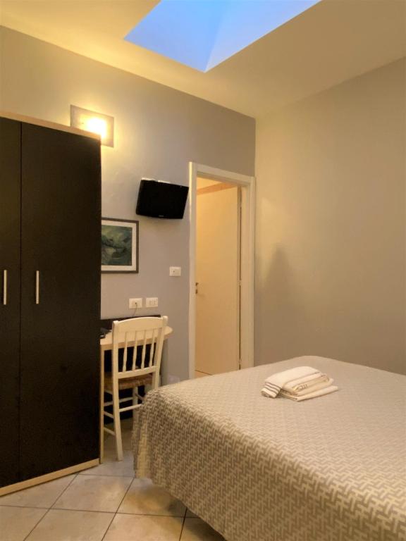 Postel nebo postele na pokoji v ubytování Hotel Lo Scudiero