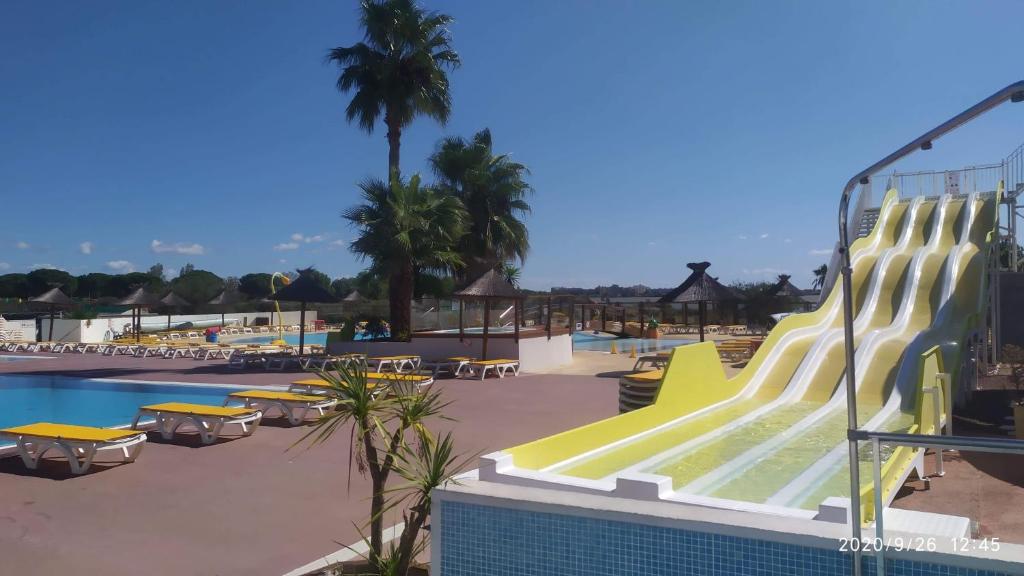 a swimming pool with a slide at a resort at MKLK ,3 chambres 2salles de bains in Lattes