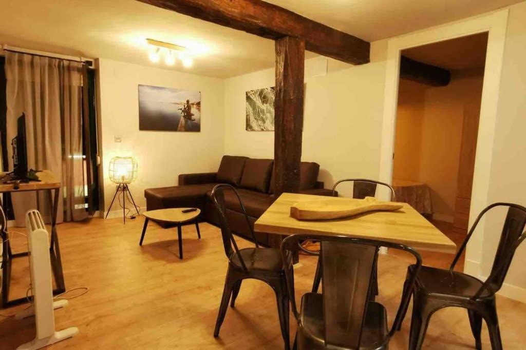 a living room with a table and a couch at Acogedor apartamento en el Centro de Santander in Santander