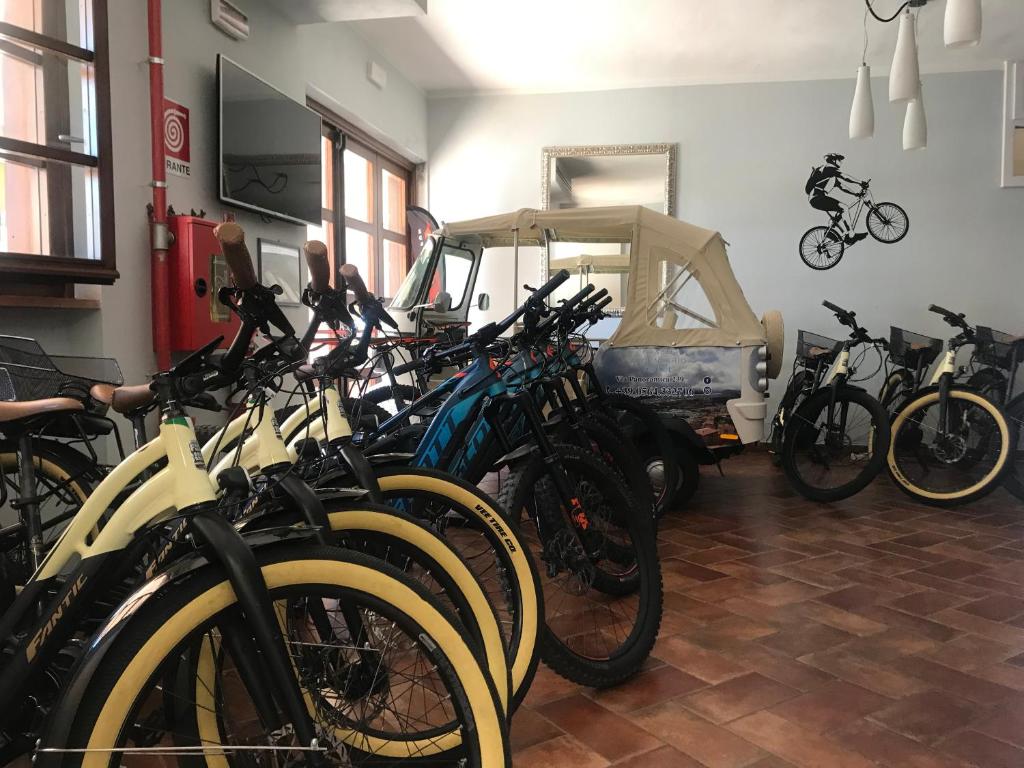 a room with a bunch of bikes parked in it at Bike&Boat Argentario Hotel in Porto Santo Stefano