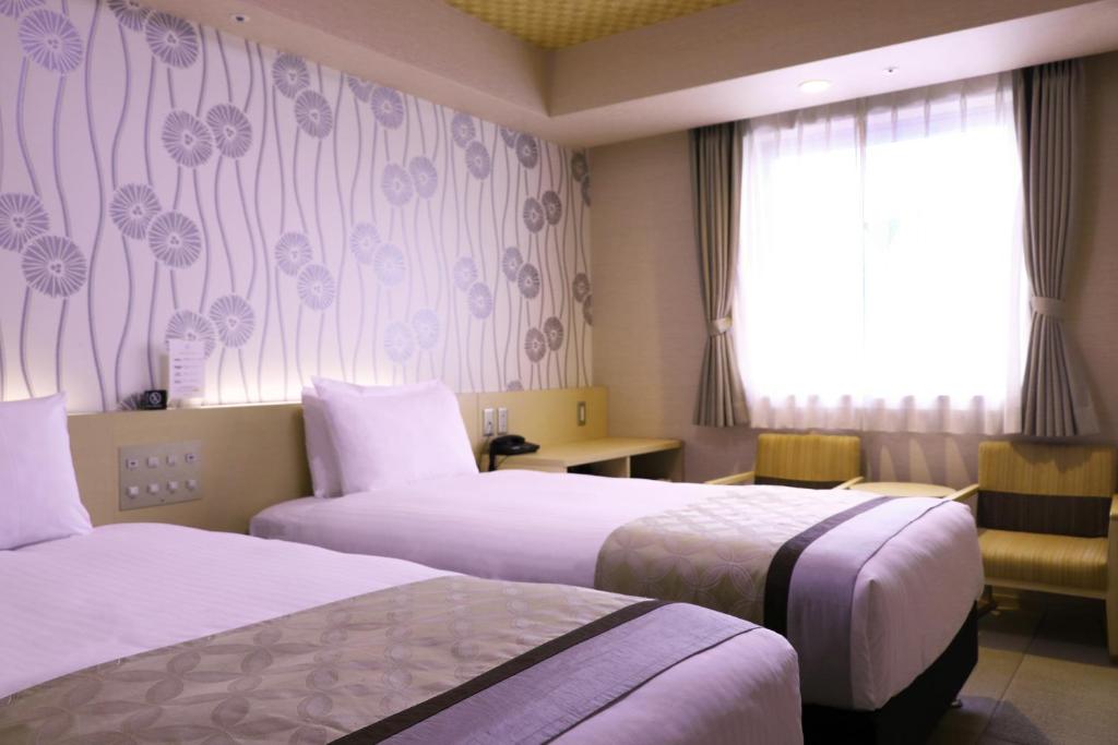 Postel nebo postele na pokoji v ubytování Hot Spring Osaka Hinode Hotel Nipponbashi