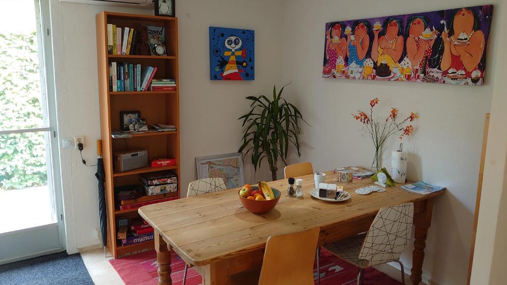 a dining room table with a bowl of fruit on it at Het Koekoeksnest-Nieuwegein in Nieuwegein