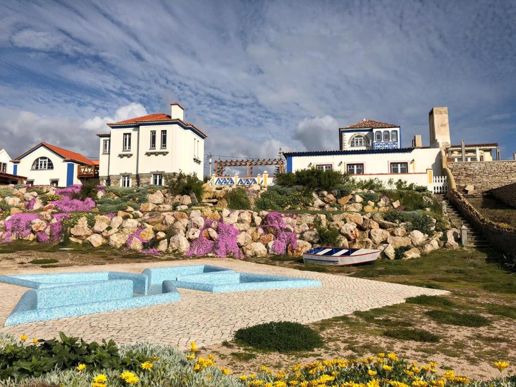 a house on a rocky hill with a swimming pool at Chalet O Amorzinho Sintra Praia in Sintra