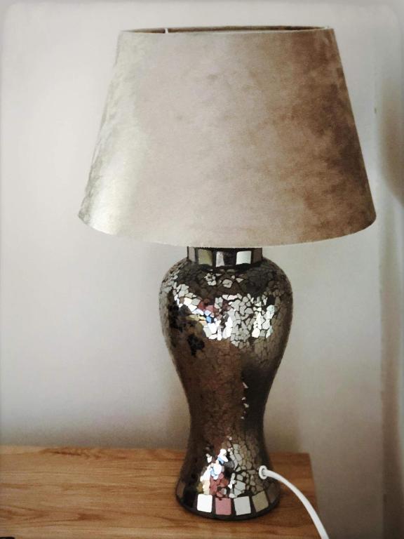 a lamp sitting on a table with a lampshade on it at Richmond Luxury flat Fabulous location in Southend-on-Sea