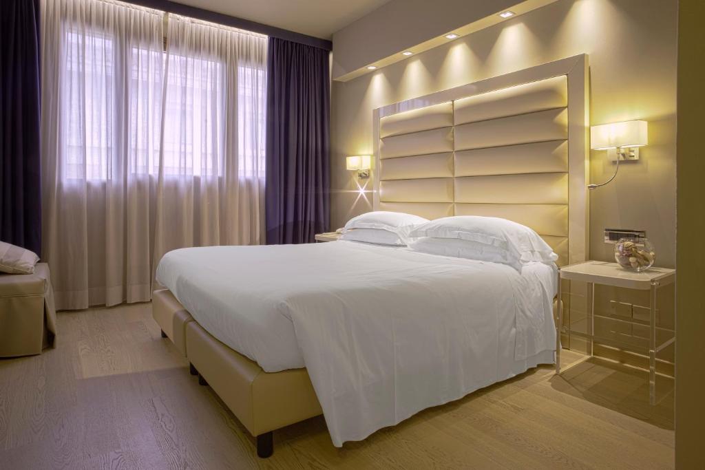Postel nebo postele na pokoji v ubytování Hotel Touring