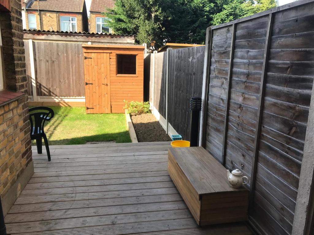 a wooden deck with a bench and a fence at Richmond Luxury flat Fabulous location in Southend-on-Sea