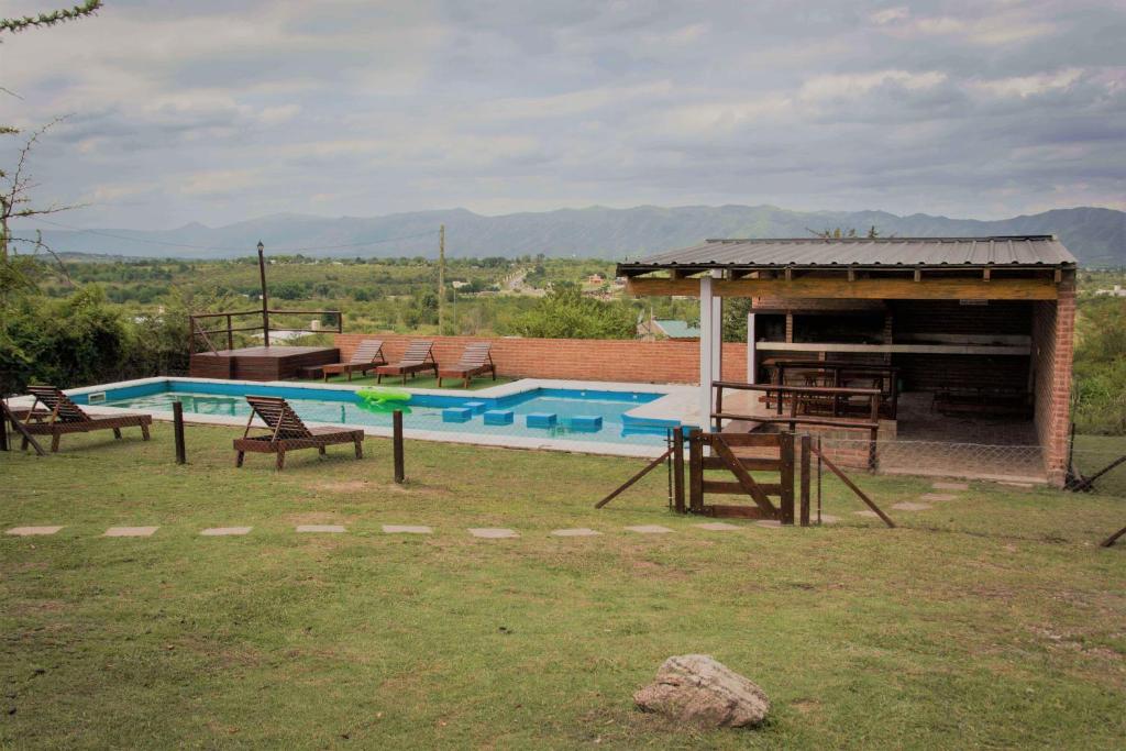 a swimming pool with a frisbee in the yard at Complejo Acanto in Villa Carlos Paz