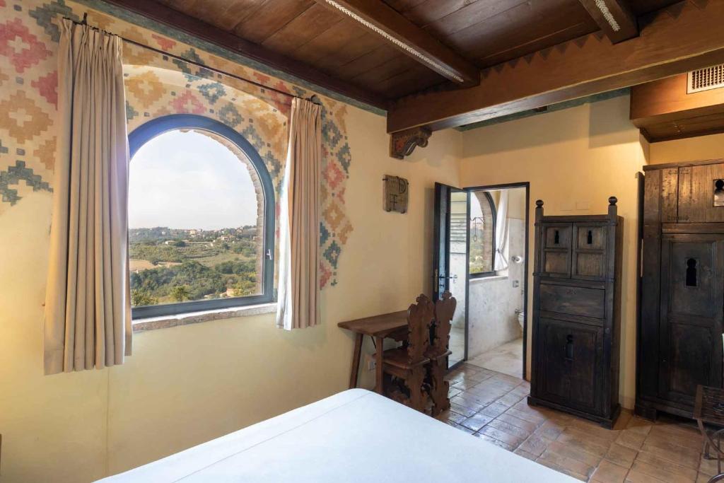 Postel nebo postele na pokoji v ubytování Castello Di Monterone