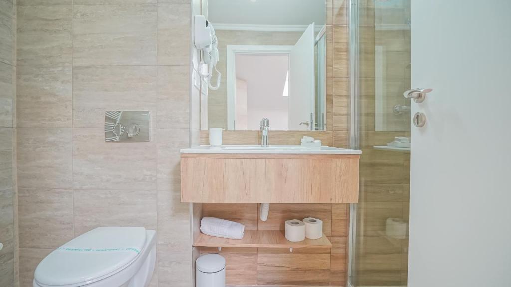 a bathroom with a sink and a toilet at Monarch House in Braşov