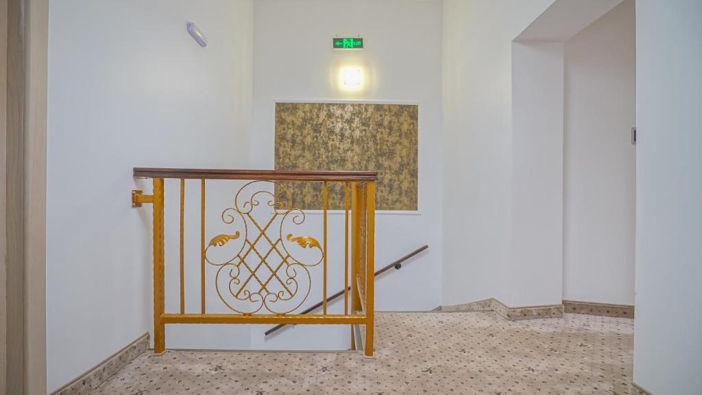 a console in a room with a painting on the wall at Monarch House in Braşov
