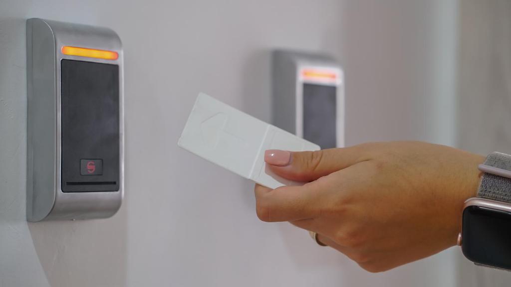 a hand holding a piece of paper in an elevator at Monarch House in Braşov