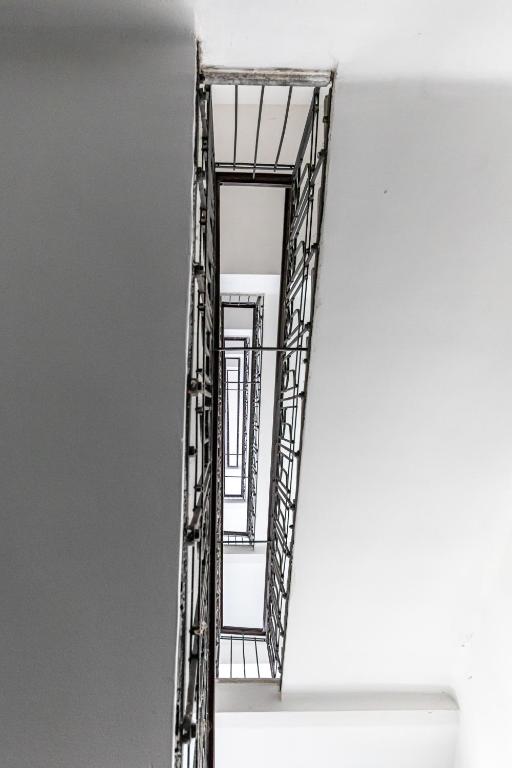 a staircase in a white wall with a metal ladder at Ley Apartments Vienna in Vienna