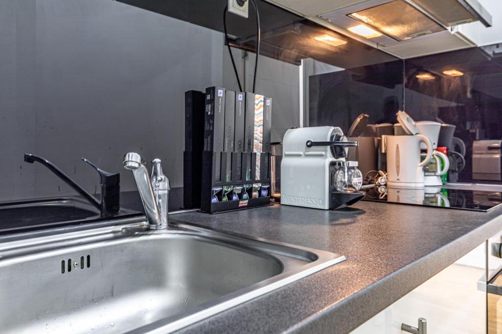 a kitchen counter with a sink and a coffee maker at Ley Apartments Vienna in Vienna