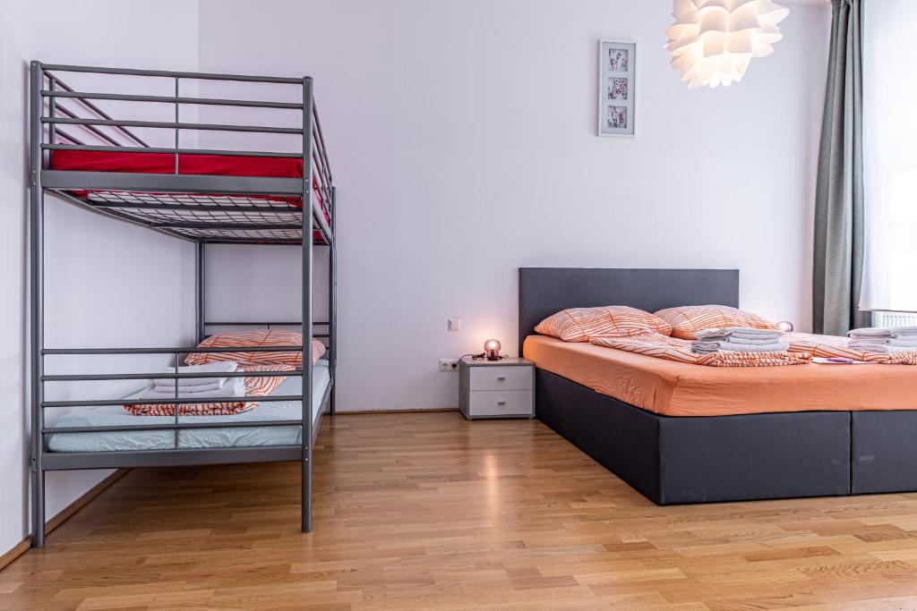 a bedroom with a bunk bed and a ladder at Ley Apartments Vienna in Vienna