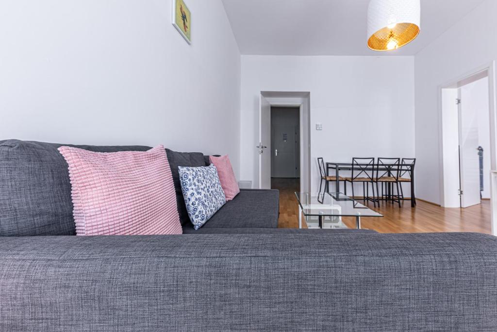 a living room with a gray couch and a table at Ley Apartments Vienna in Vienna