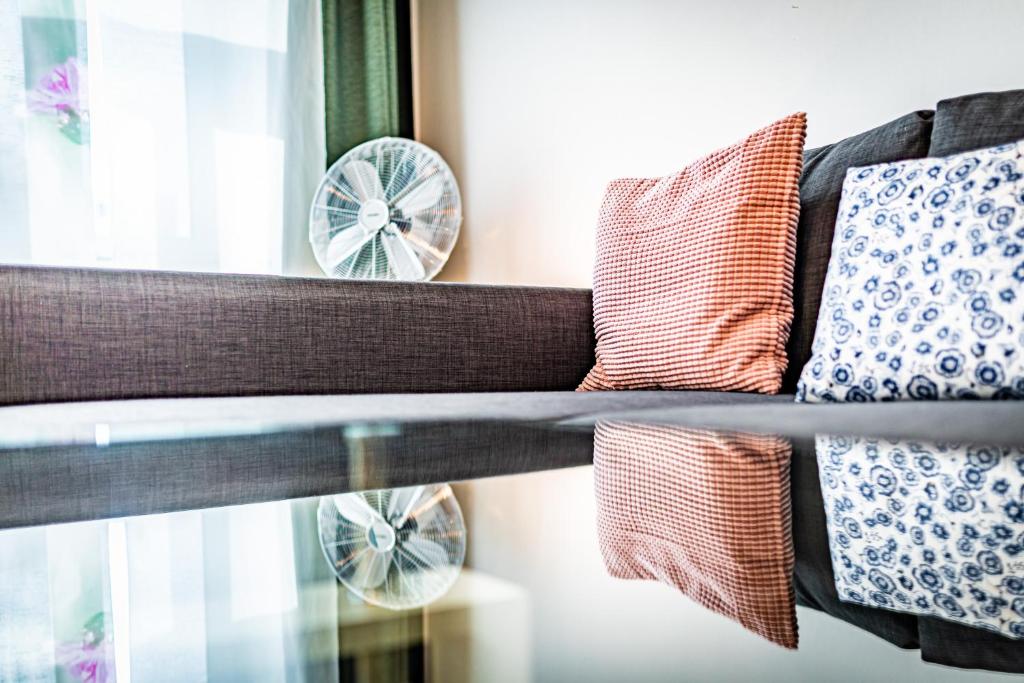 a couch sitting next to a window with pillows at Ley Apartments Vienna in Vienna
