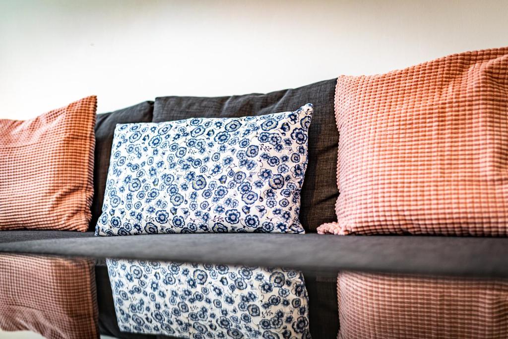 a couch with several pillows on it at Ley Apartments Vienna in Vienna