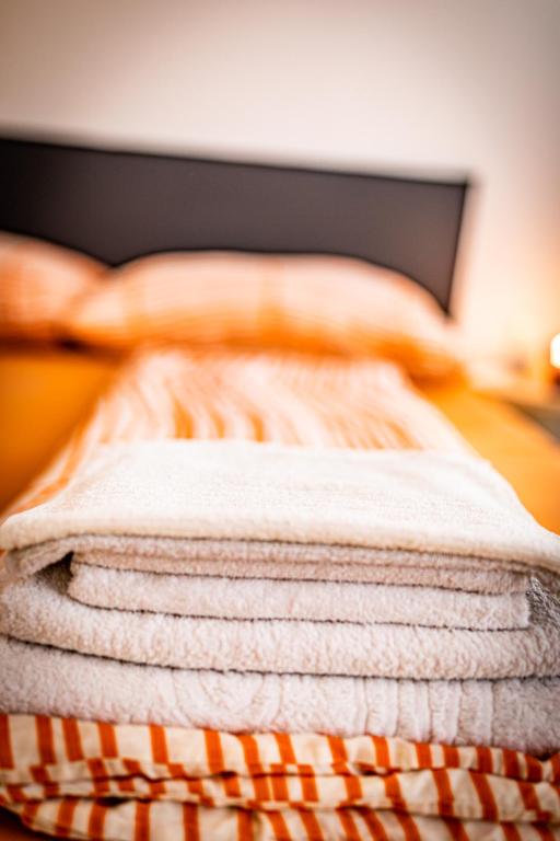 a stack of towels sitting on top of a bed at Ley Apartments Vienna in Vienna