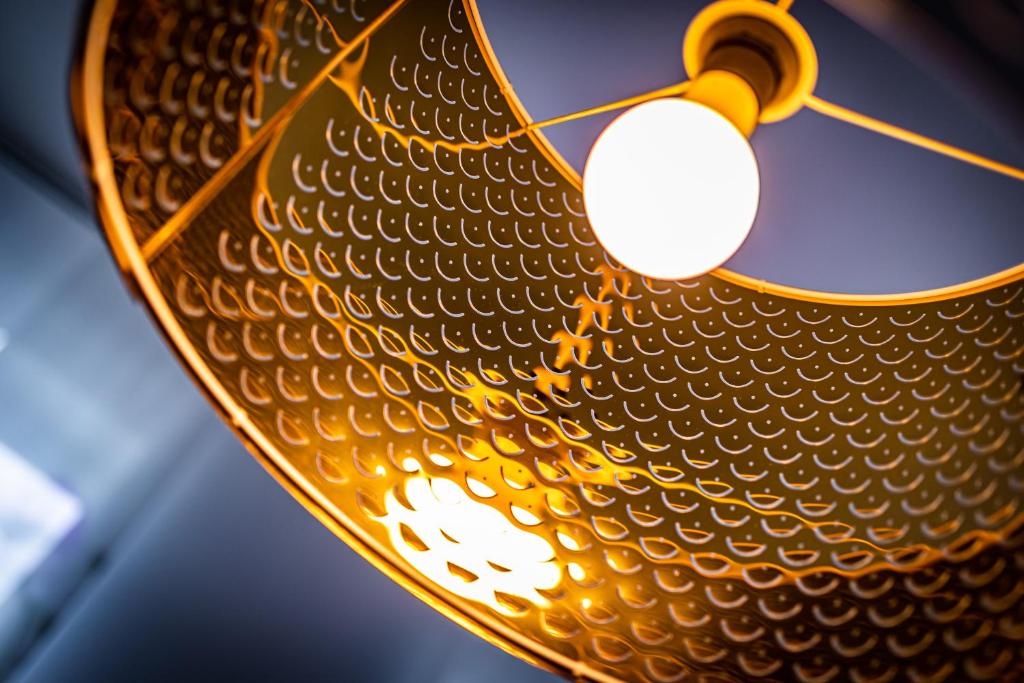 a close up of a yellow umbrella with a light at Ley Apartments Vienna in Vienna