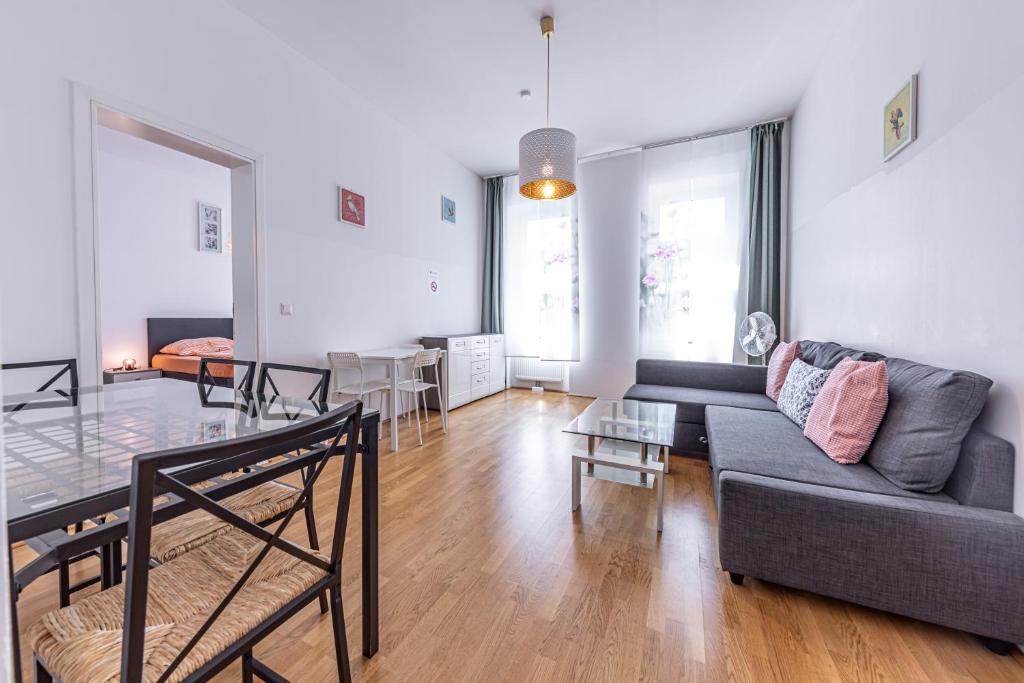 a living room with a couch and a glass table at Ley Apartments Vienna in Vienna