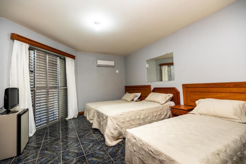 Postel nebo postele na pokoji v ubytování Canzi Cataratas Hotel