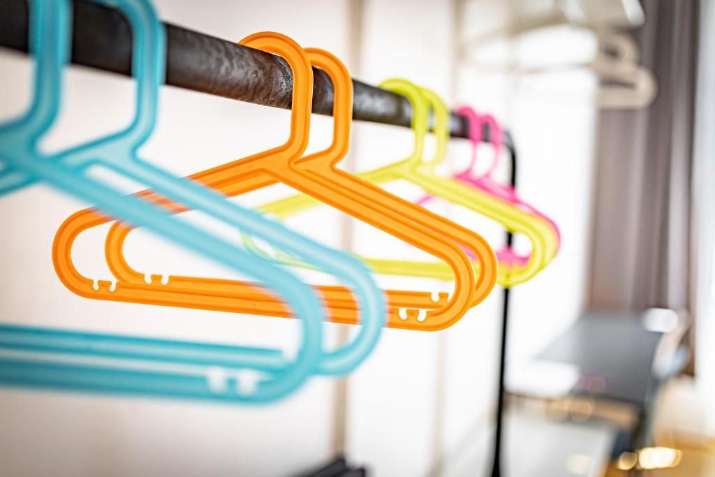 a row of colorful hoses hanging in a room at Ley Apartments Vienna in Vienna