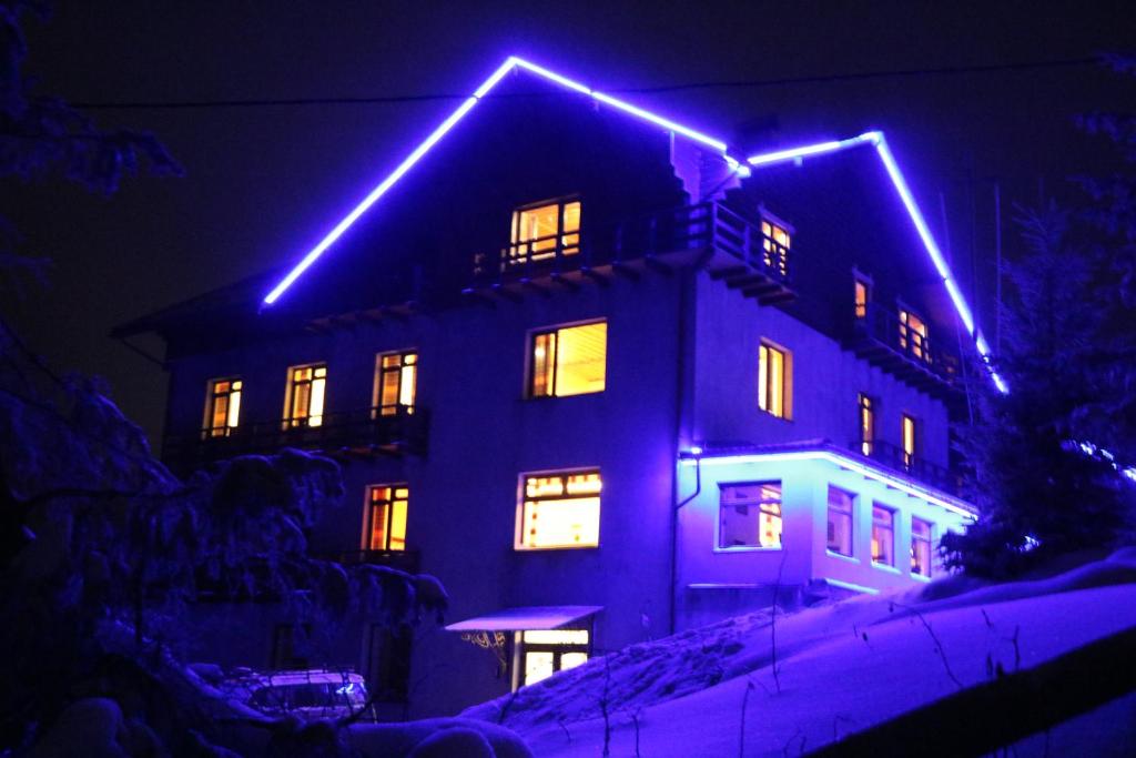 a building with lights on top of it at night at Оселя Драгобрат in Dragobrat