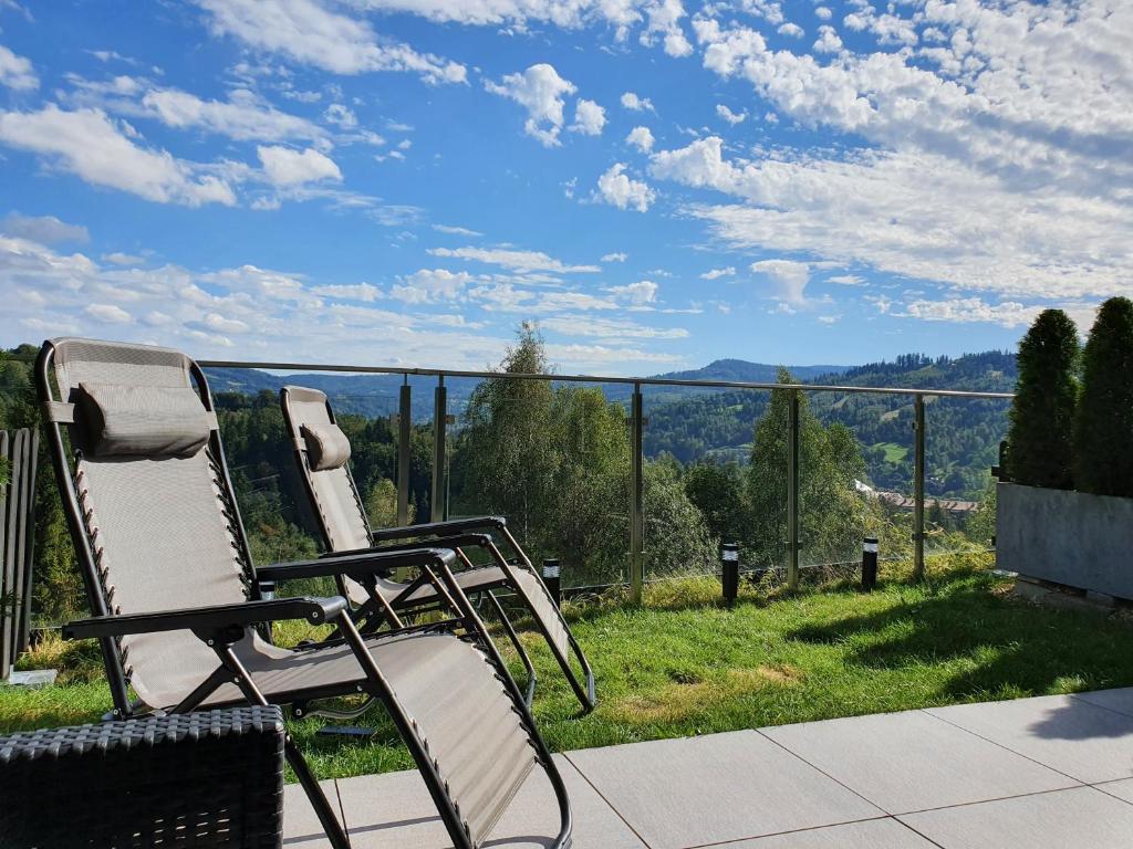 two chairs sitting on a patio with a view at Apartament Widokowy Wisła in Wisła