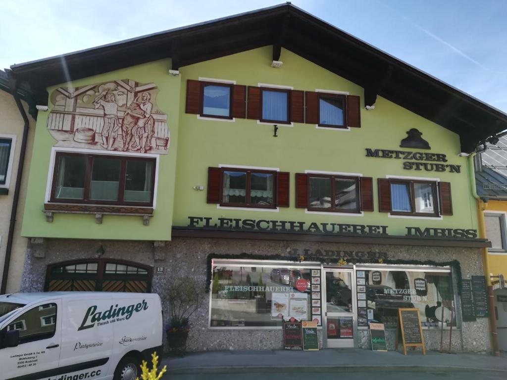 a building with a van parked in front of it at Apartment Ladinger in Radstadt