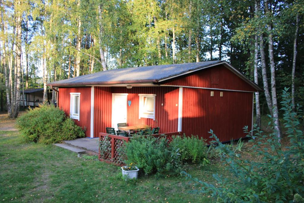 Cabaña roja con porche en el bosque en Czerwony Domek, en Tleń