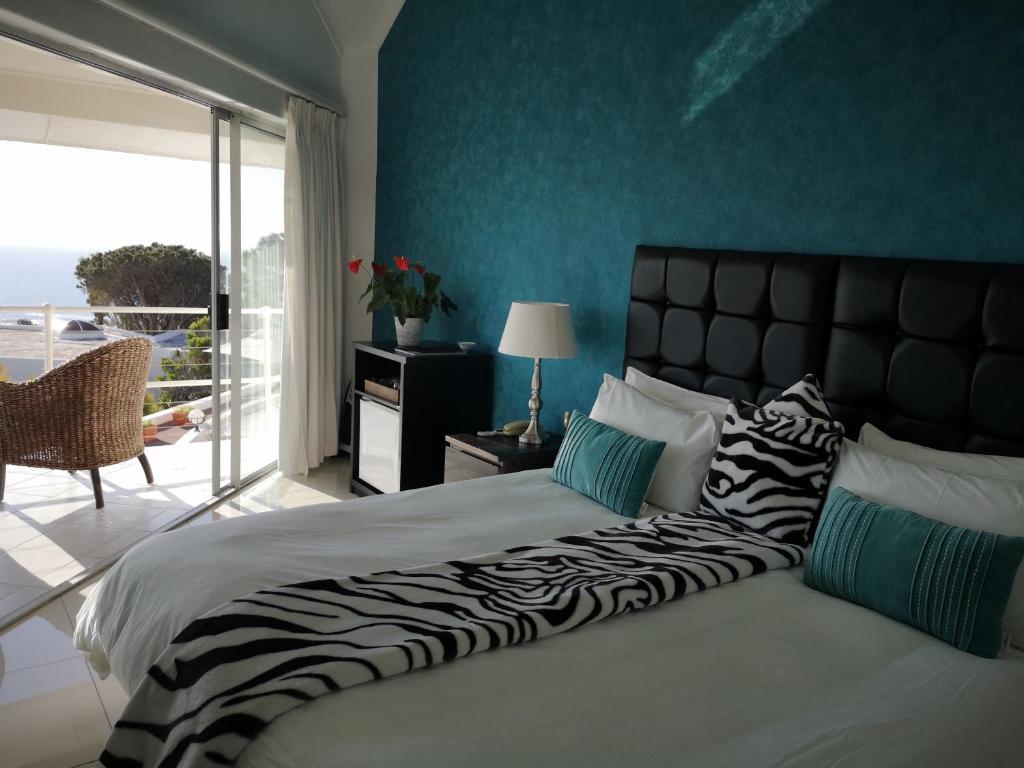 a bedroom with a large bed with a zebra blanket at Diamond House Guesthouse in Cape Town