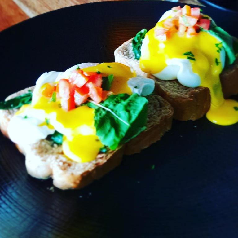 two eggs on toast on a blue plate at Ubud Season Villas in Ubud