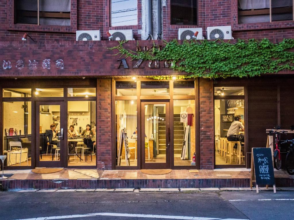 a store front of a restaurant with people sitting at tables at Bacchus Kofu Guesthouse in Kofu