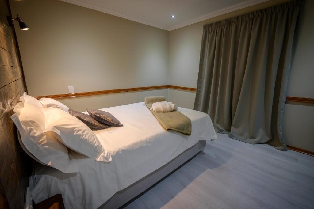 Ένα ή περισσότερα κρεβάτια σε δωμάτιο στο Bains Lodge