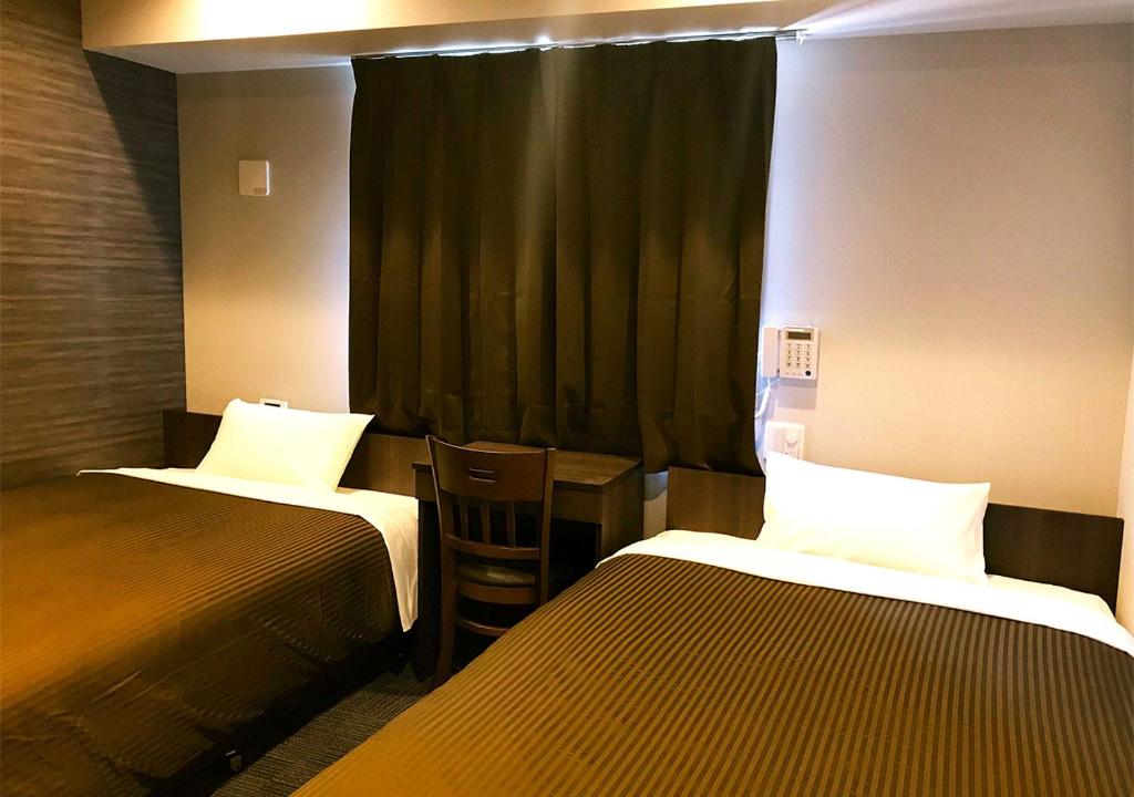 Postel nebo postele na pokoji v ubytování Hotel Trend Omiya