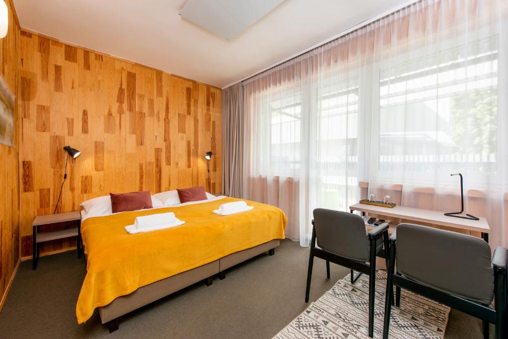 Postel nebo postele na pokoji v ubytování Hotel Veverica