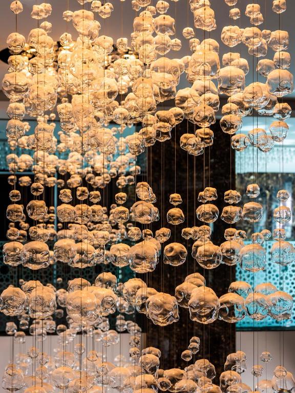 a display of chandeliers in a store window at Royal Tulip Muscat in Muscat