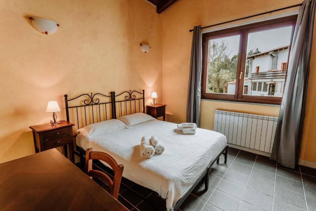 A bed or beds in a room at Vallicciola Nature Hotel
