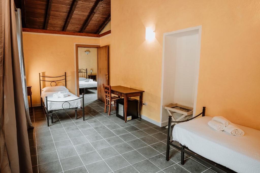 A bed or beds in a room at Vallicciola Nature Hotel