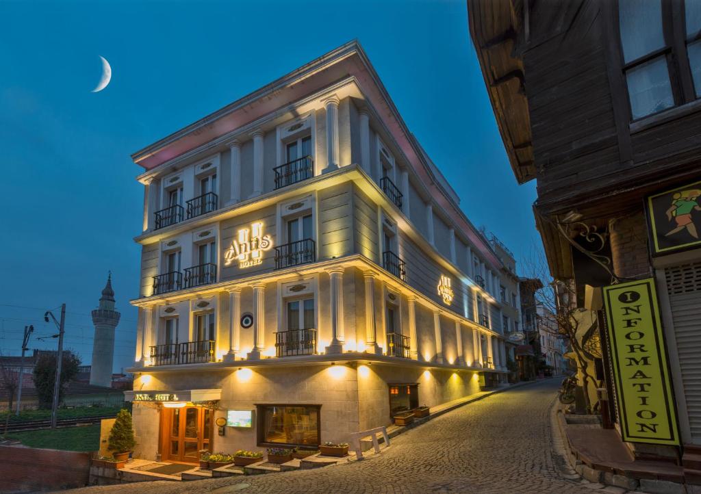 a large white building with lights on a street at Antis Hotel-Special Category in Istanbul