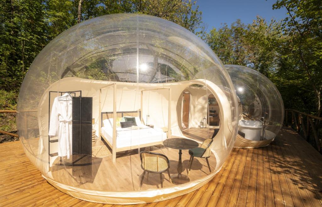 two glass domes with a bedroom and a bed inside at Ursa Major Bubble in Camporgiano