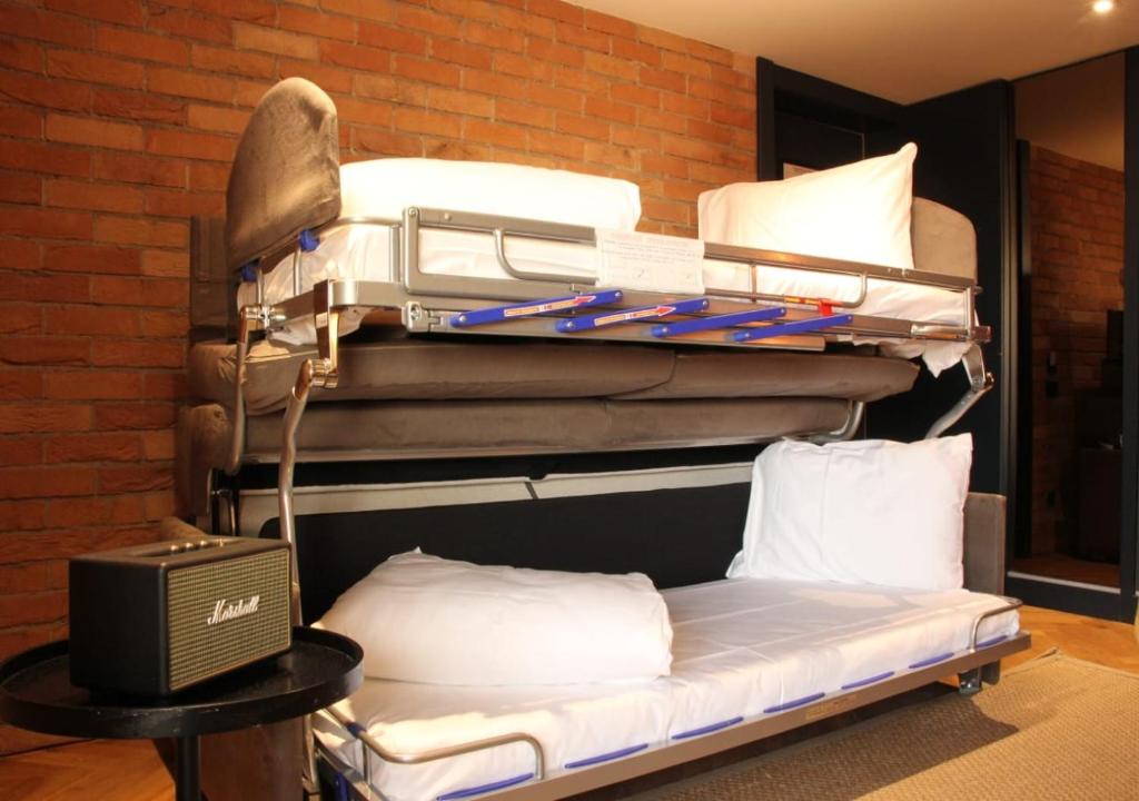 a stack of bunk beds in a room at Caro Hotel in Bucharest