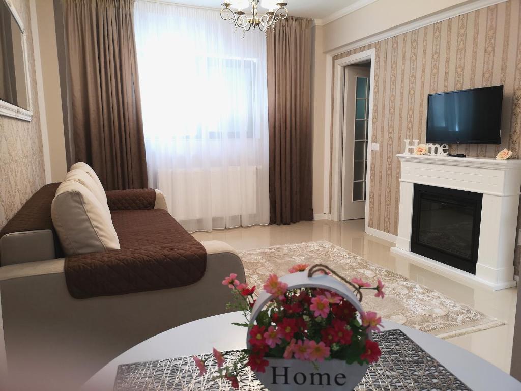 a living room with a couch and a fireplace at YNS Rooms in Iaşi