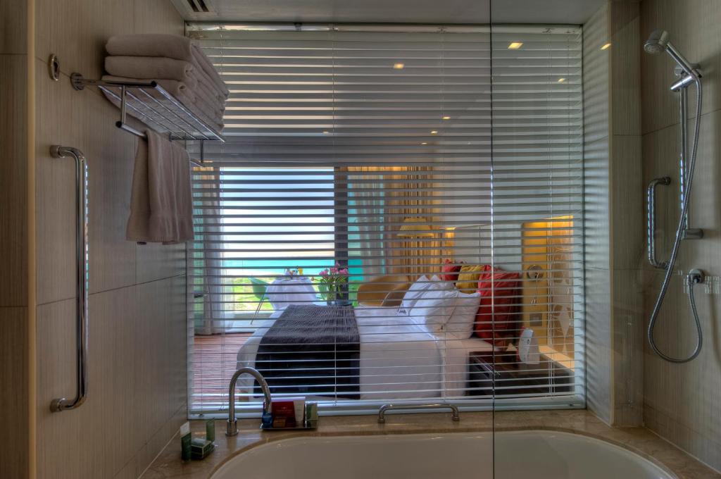 a bath tub with a window in a bathroom at Crowne Plaza Yas Island by IHG in Abu Dhabi